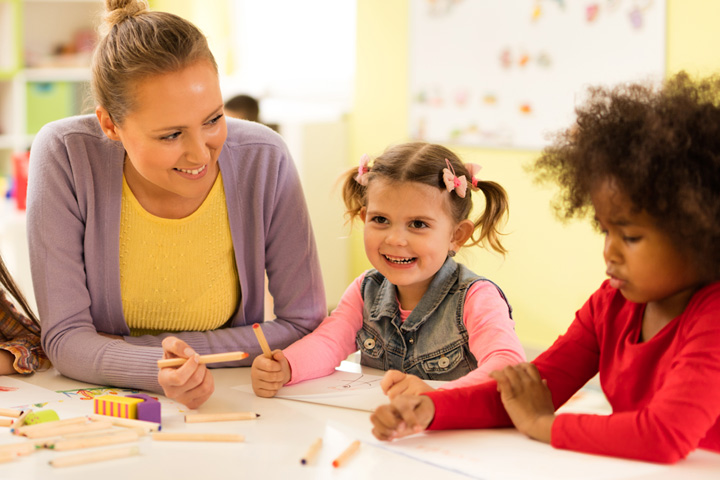 Young female teacher with children